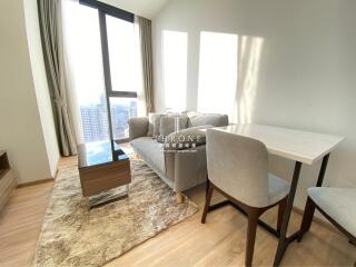 Modern living room with large windows and city view