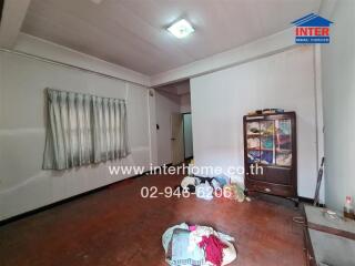 Spacious bedroom in need of repair with wooden flooring