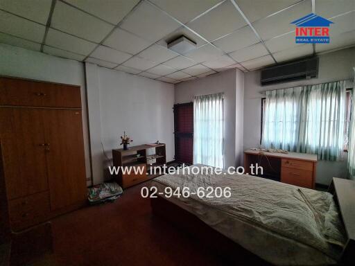 Spacious bedroom with large windows and ample natural light