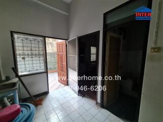 Spacious kitchen with large windows and wooden cabinets