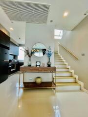 Elegant living room with staircase and modern decor