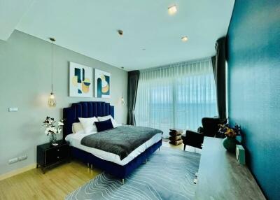 Elegant modern bedroom with blue accents and artistic decor