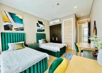 Modern twin bedroom with vibrant decor and ample natural light