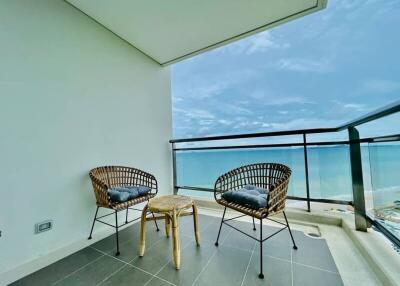 Spacious balcony with ocean view and modern seating