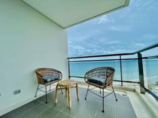 Spacious balcony with ocean view and modern seating