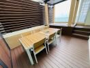 Spacious balcony with wooden furniture and sea view