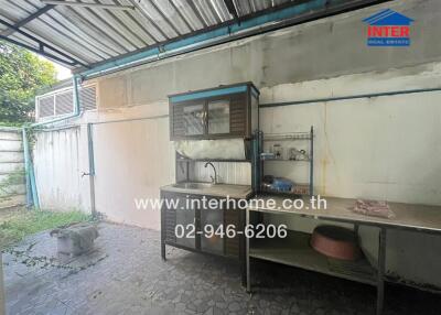 Spacious outdoor kitchen with metal roofing and basic amenities