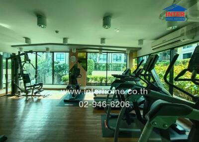 Modern gym facility in a residential building with various exercise equipment