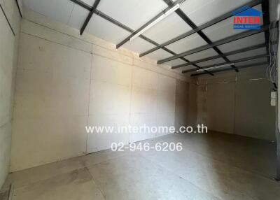 Spacious empty indoor space in a building with bare walls and minimal features