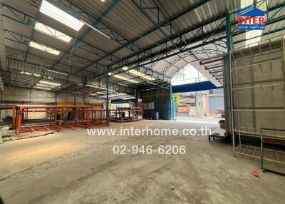 Spacious industrial warehouse interior with high ceilings and storage equipment
