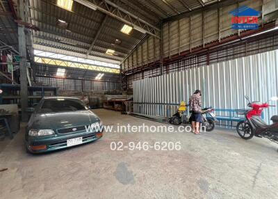 Industrial warehouse interior with vehicles and equipment