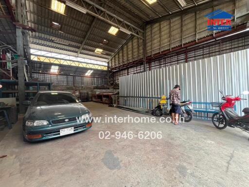 Industrial warehouse interior with vehicles and equipment