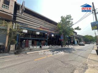 Street view of commercial storefronts featuring multiple shops