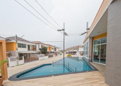 Spacious outdoor swimming pool with modern surrounding buildings