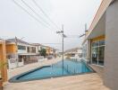 Spacious outdoor swimming pool with modern surrounding buildings