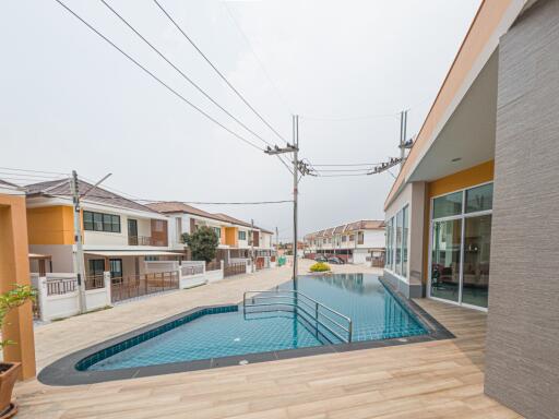 Spacious outdoor swimming pool with modern surrounding buildings