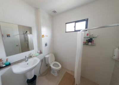 Spacious and well-equipped bathroom with modern amenities and natural light