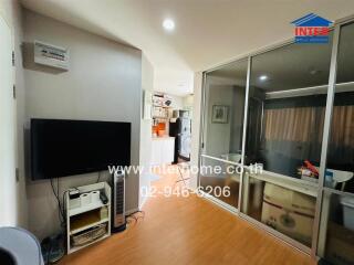 Modern living area with open sliding glass doors to kitchen