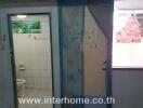 Compact bathroom with blue shower curtain and exterior door