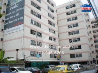 Exterior view of a multi-story residential building with advertisement banners