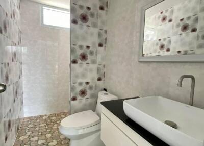 Modern bathroom with artistic tile design and stylish fixtures