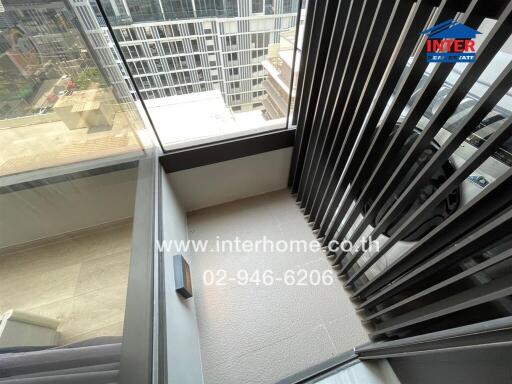 Spacious balcony with safety railings and city view