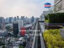 City view from high-rise balcony with lush greenery