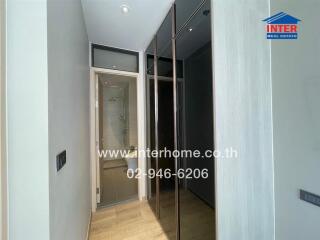 Modern hallway with glass door leading to shower and mirrored wardrobe