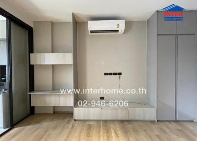 Modern living room with built-in shelves and air conditioning unit