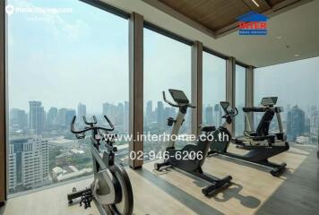 Modern gym within a high-rise building featuring floor-to-ceiling windows with city views