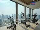 Modern gym within a high-rise building featuring floor-to-ceiling windows with city views