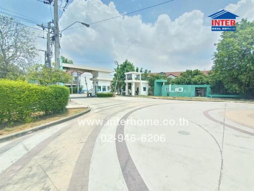 Street view of a residential neighborhood with curved road and modern houses