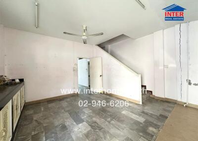 Spacious kitchen in need of renovation with tiled flooring and natural light
