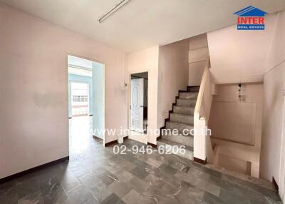 Spacious living room with staircase and balcony access