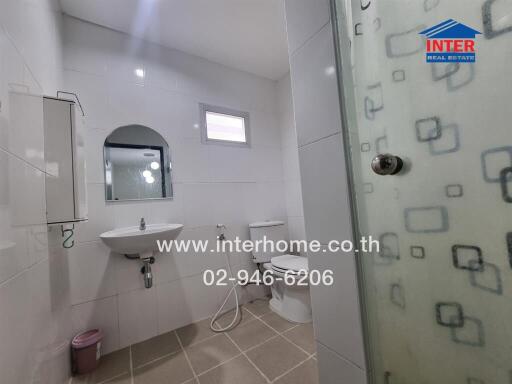 Modern bathroom with glass shower and wall-mounted sink