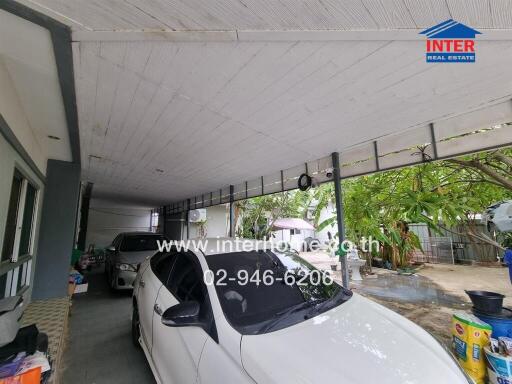 Spacious covered garage with two cars and ample storage space