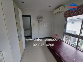 Spacious bedroom with large window and built-in wardrobe