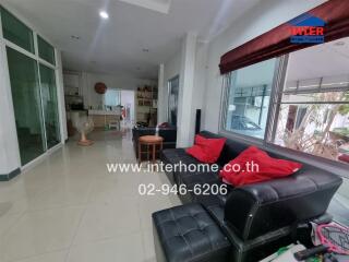 Spacious living room with leather sofa and large windows