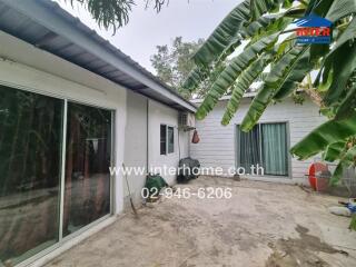 Exterior view of a suburban house with lush greenery