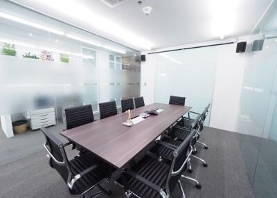 Modern and spacious meeting room with black chairs and a large table