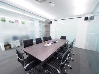 Modern and spacious meeting room with black chairs and a large table