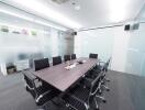 Modern and spacious meeting room with black chairs and a large table