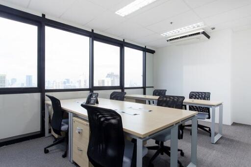 Spacious office room with large windows and city view