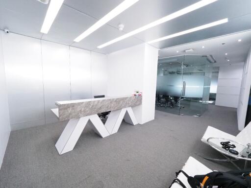 Modern office space with minimalist white design and marble accents