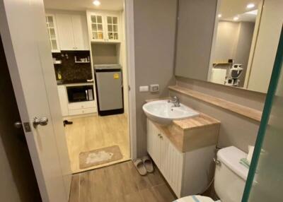 Compact modern bathroom with integrated laundry area