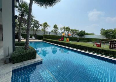 Luxurious outdoor swimming pool with landscape and children