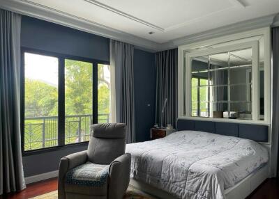 Elegant bedroom with large windows and comfortable seating