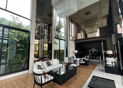 Spacious and luxurious living room with large windows and modern decor