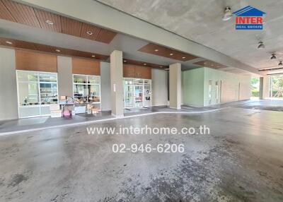 Modern apartment building lobby with wooden ceiling and columns