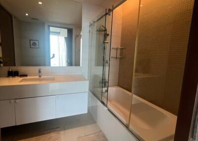 Modern bathroom with bathtub and glass shower partition